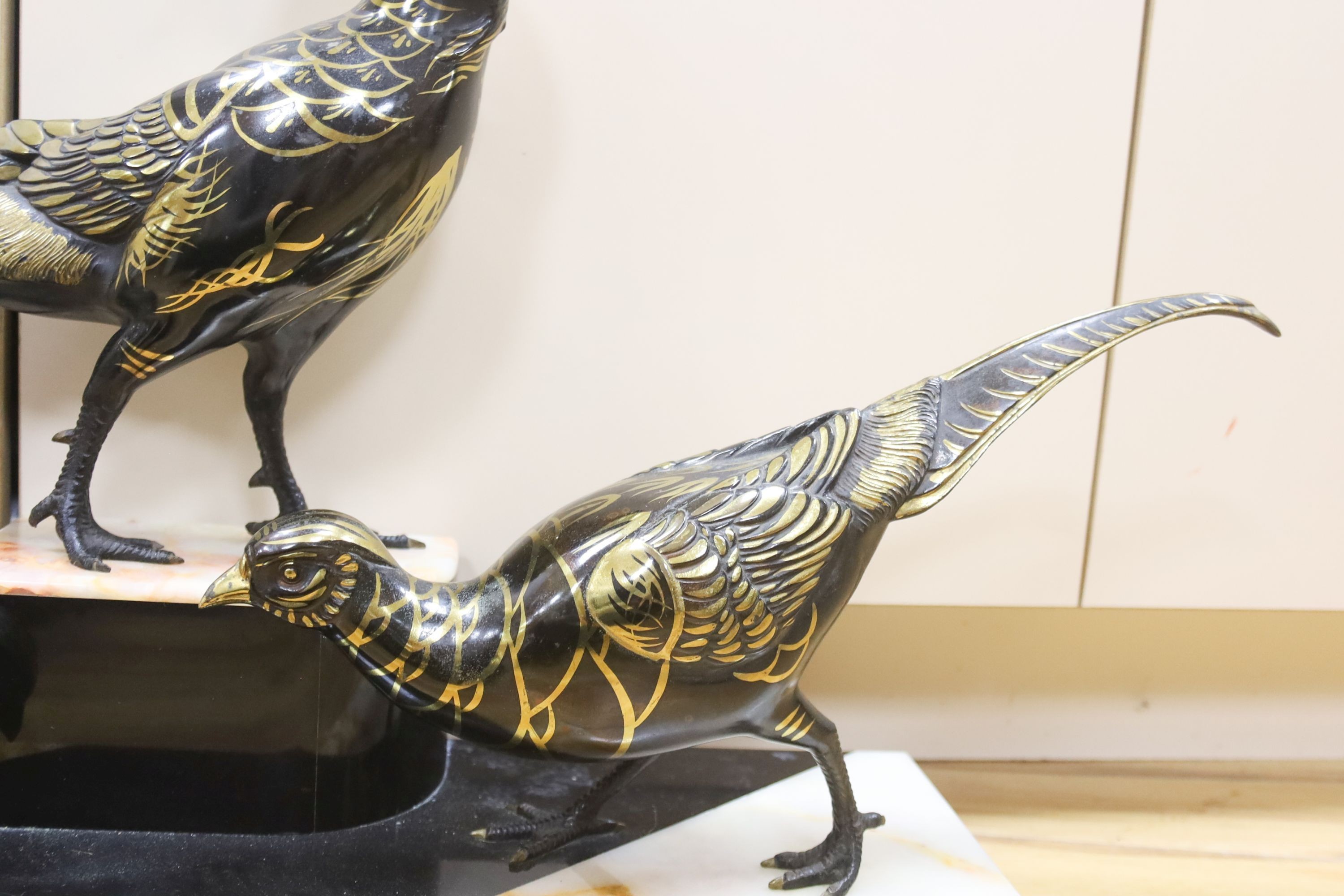 An Art Deco cold painted and gilded spelter model of 3 pheasants on a black and rouge marble base, 89cm
